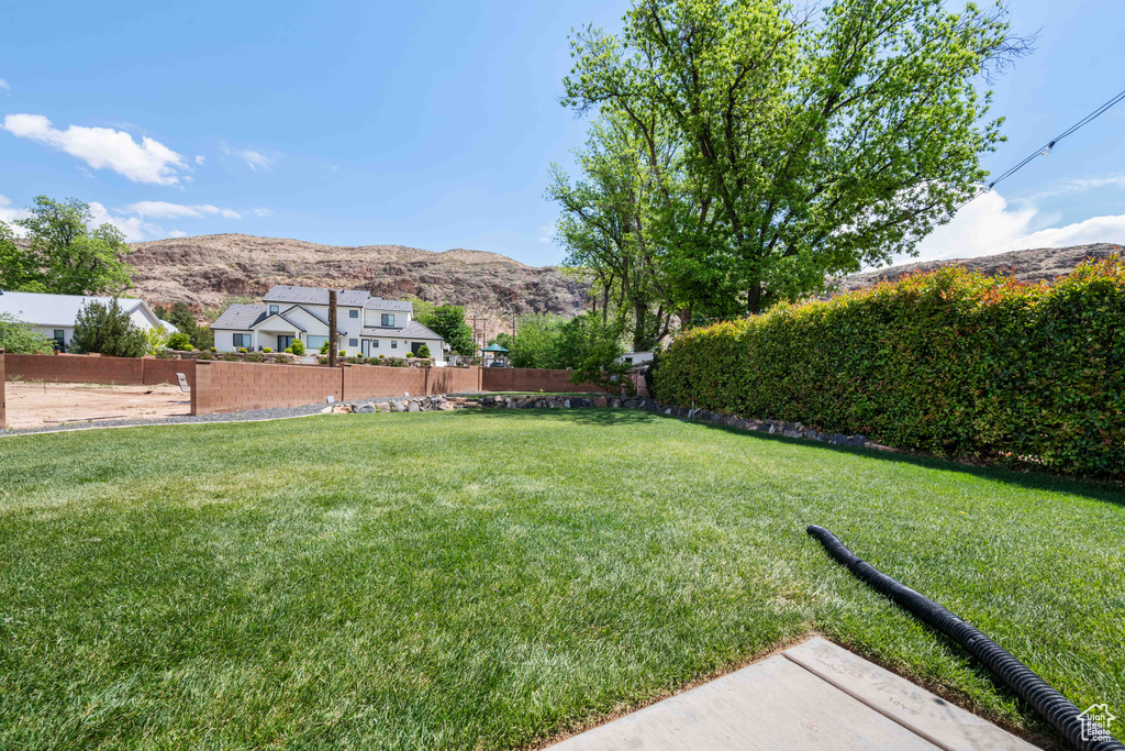 View of yard with fence and a mountain view