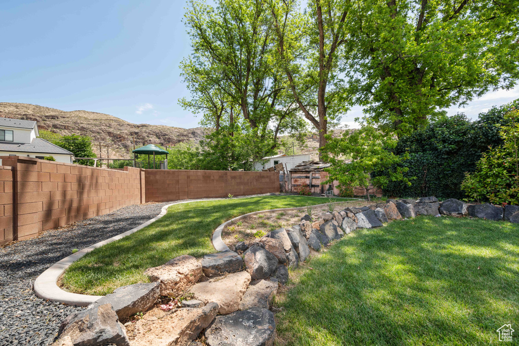 View of yard featuring fence and a mountain view