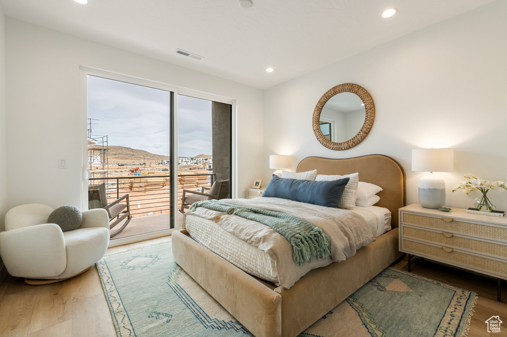 Bedroom featuring access to outside, recessed lighting, wood finished floors, and visible vents