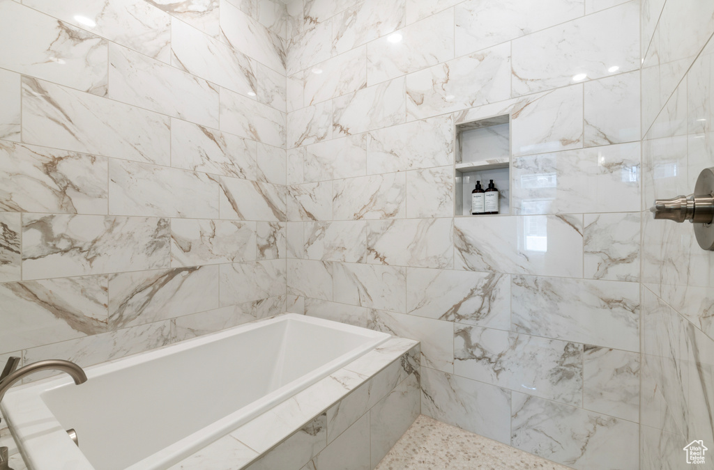 Full bathroom featuring tiled shower and tiled tub