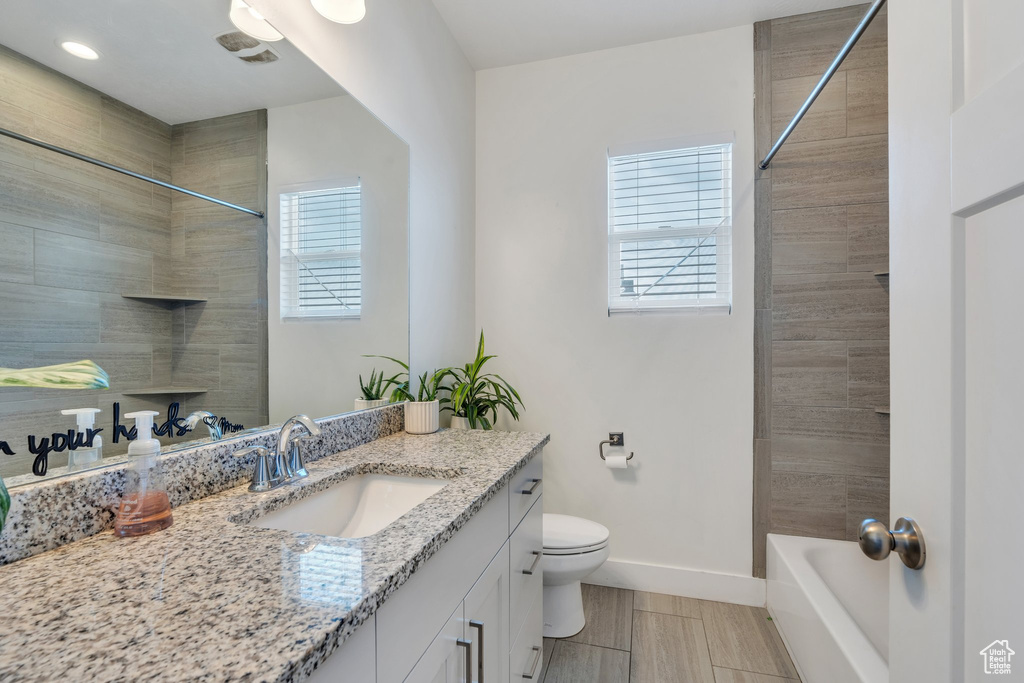 Full bath featuring toilet, baseboards, and vanity