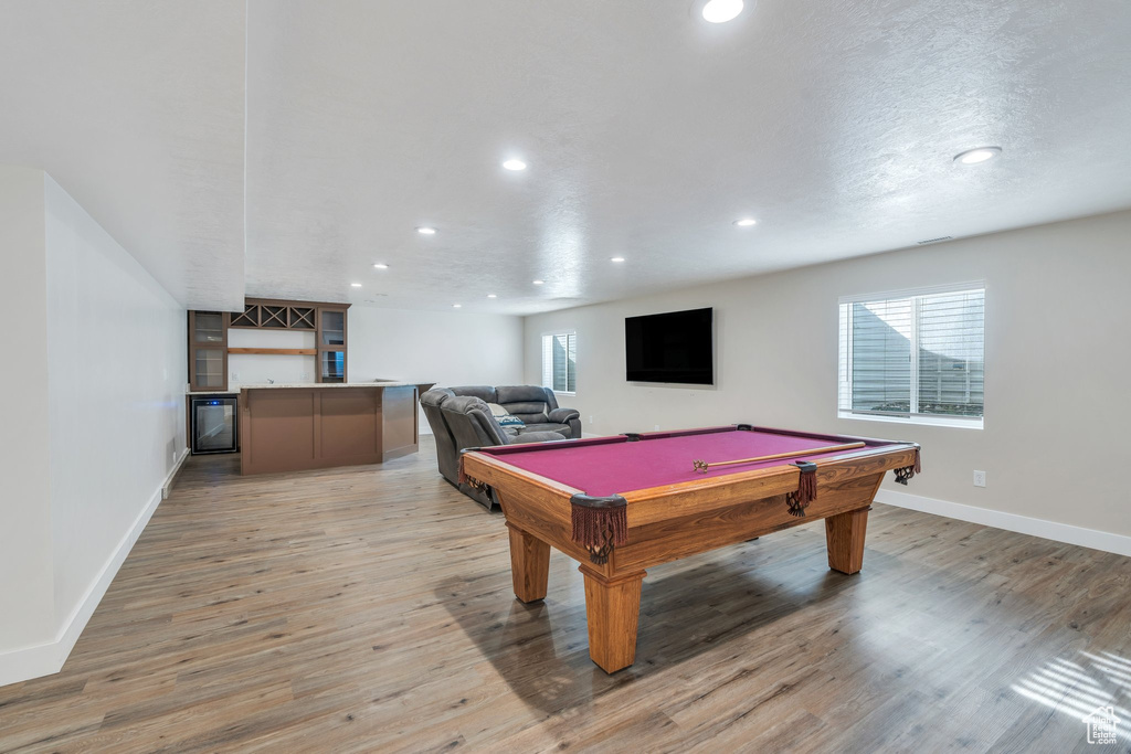Rec room with baseboards, billiards, recessed lighting, a dry bar, and light wood-style flooring