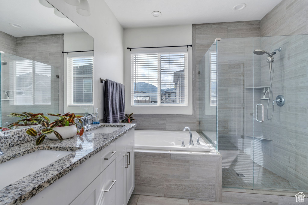 Full bath with a sink, a shower stall, and a bath