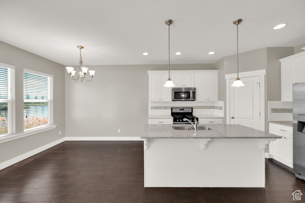 Kitchen featuring recessed lighting, appliances with stainless steel finishes, backsplash, and white cabinets