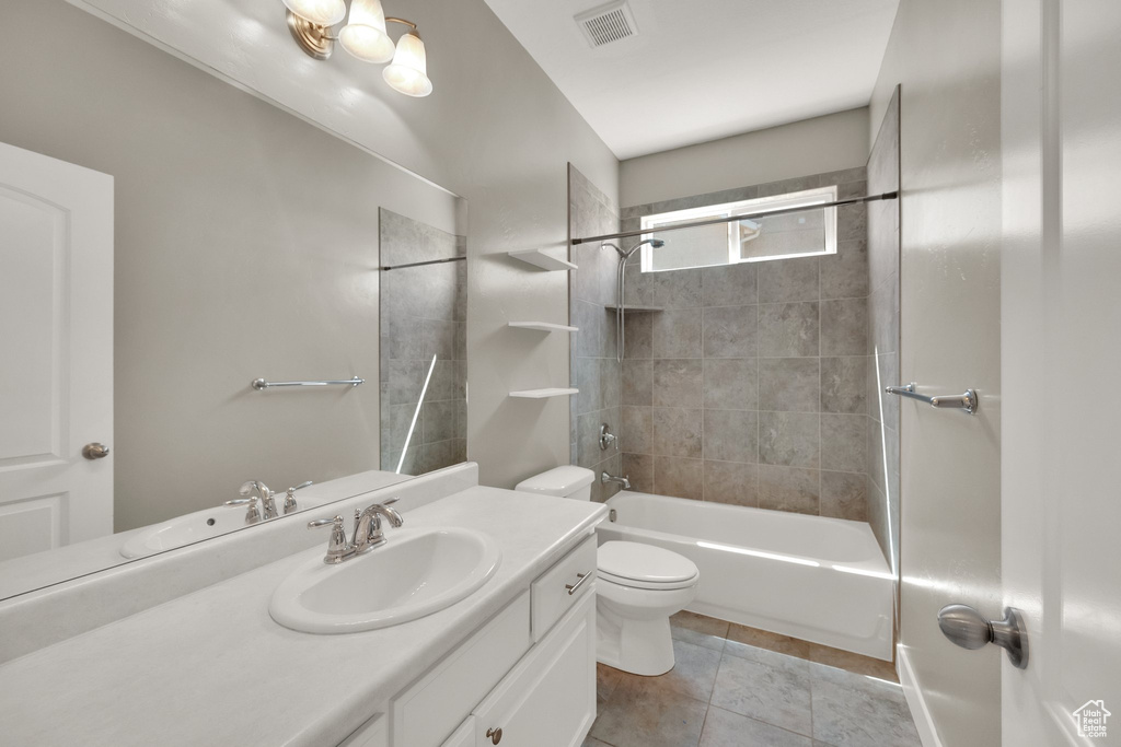 Full bathroom featuring vanity, toilet, tile patterned floors, bathing tub / shower combination, and visible vents
