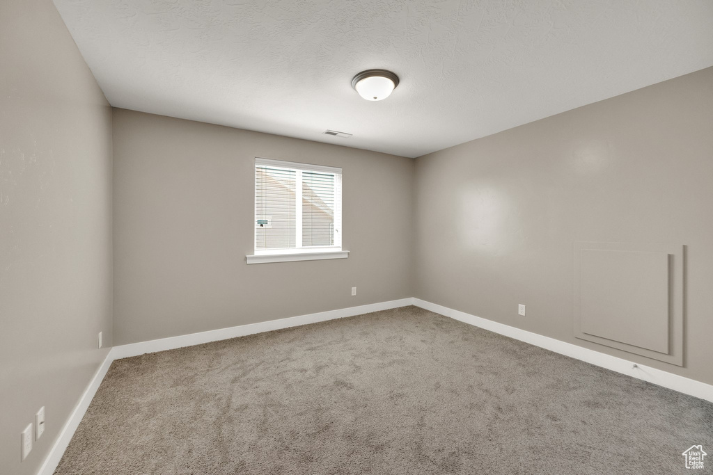 Spare room with carpet floors and baseboards