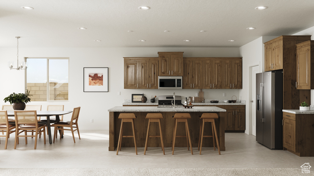 Kitchen with recessed lighting, stainless steel appliances, a kitchen bar, and a notable chandelier