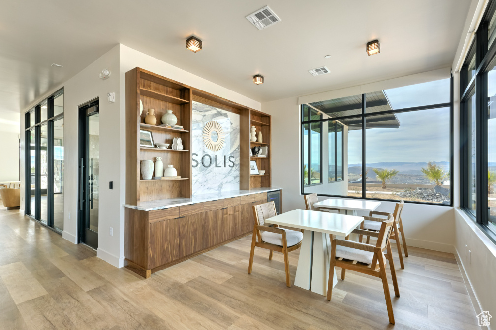 Dining room featuring visible vents, a wealth of natural light, and light wood-type flooring