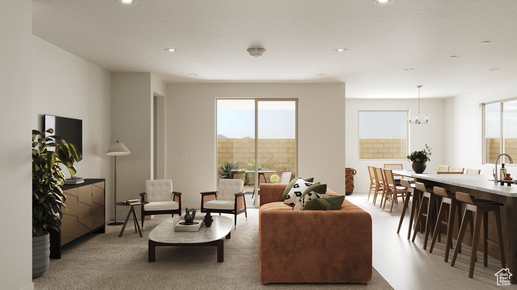 Living room featuring a healthy amount of sunlight, recessed lighting, and a notable chandelier