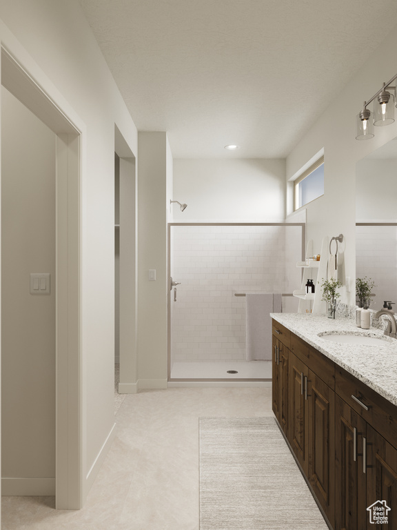 Full bathroom with vanity and tiled shower