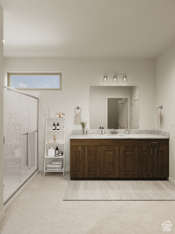 Bathroom featuring vanity, baseboards, and a shower stall