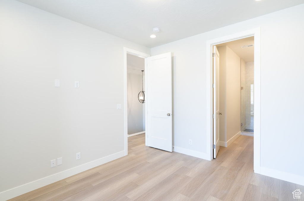 Unfurnished bedroom featuring light wood-style flooring, baseboards, and recessed lighting