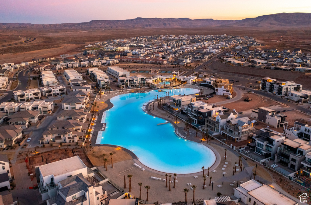 Aerial view at dusk of a mountain view and view of pool area