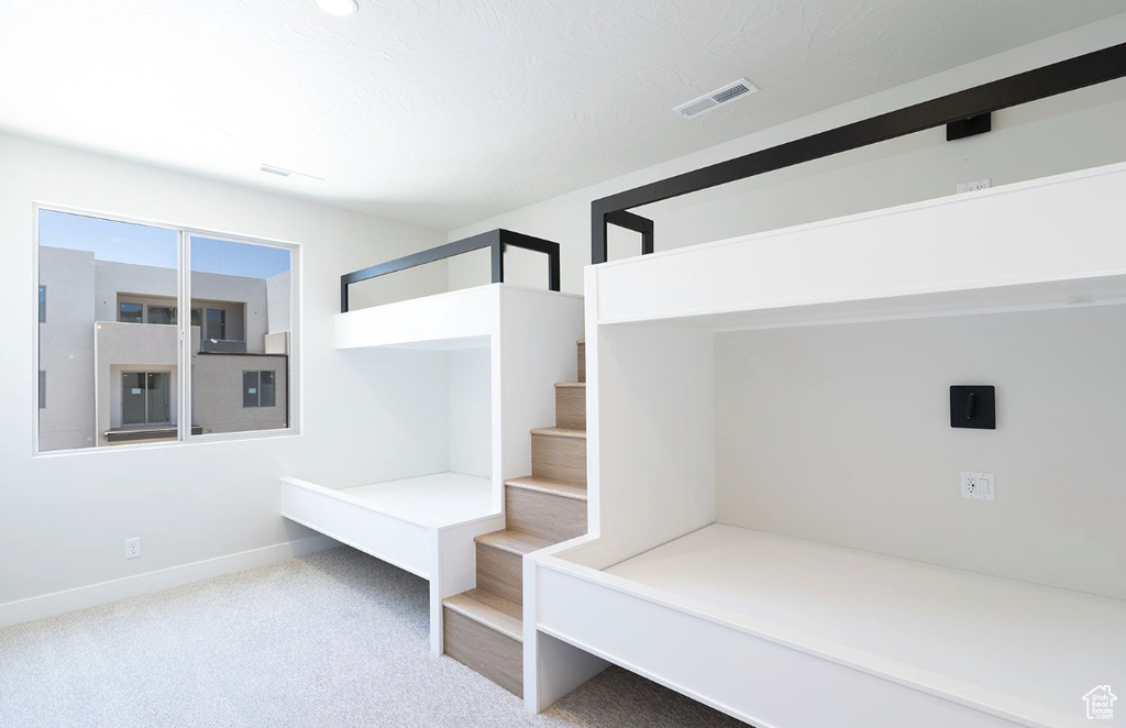 Mudroom featuring baseboards, carpet flooring, and visible vents