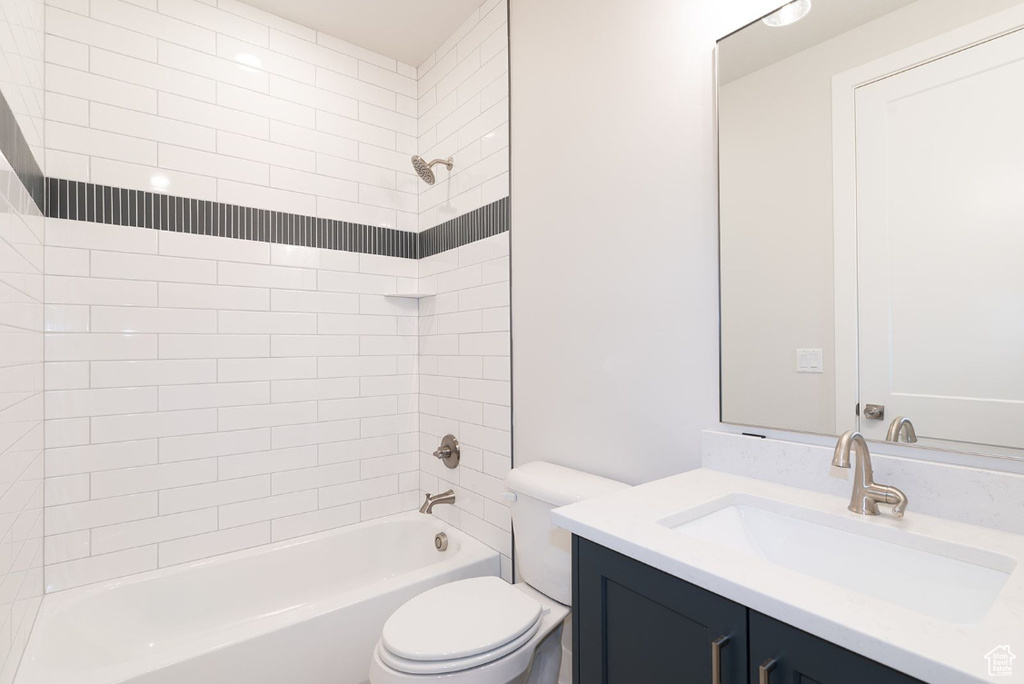 Full bath with toilet, shower / washtub combination, and vanity
