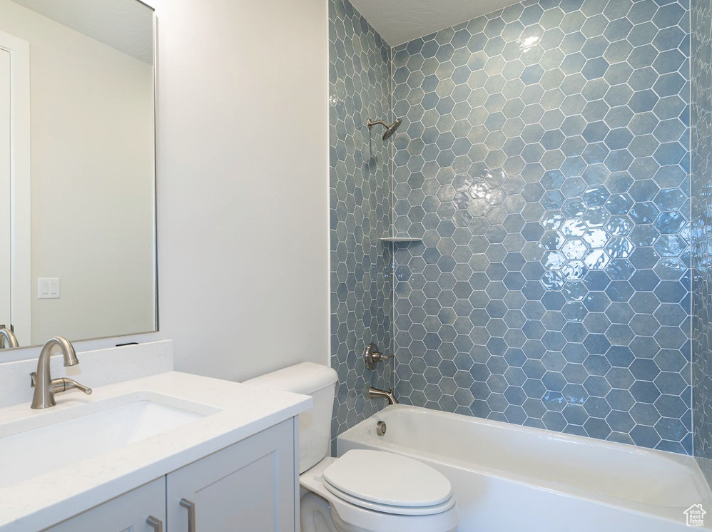 Full bathroom with vanity, toilet, and tub / shower combination