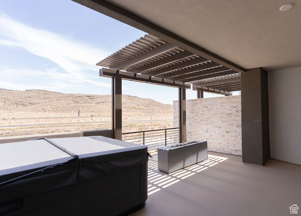 View of patio / terrace with a mountain view, a hot tub, and a pergola