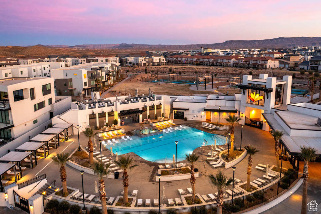 Pool at dusk featuring a community pool and a mountain view