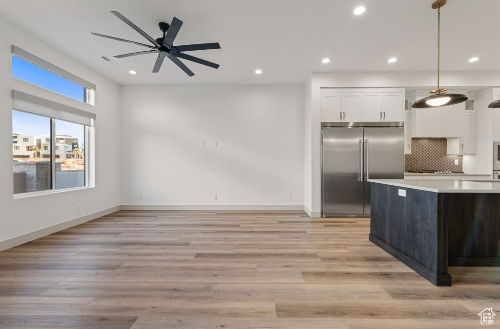 Kitchen featuring white cabinets, recessed lighting, and stainless steel built in refrigerator