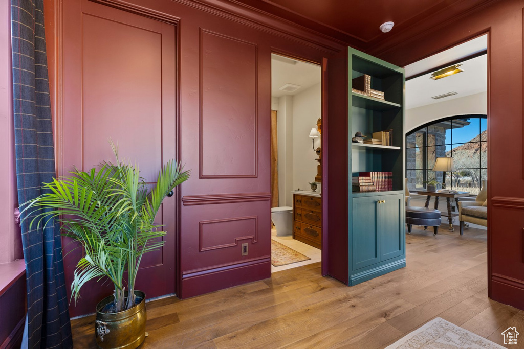 Interior space featuring ornamental molding, wood finished floors, and visible vents