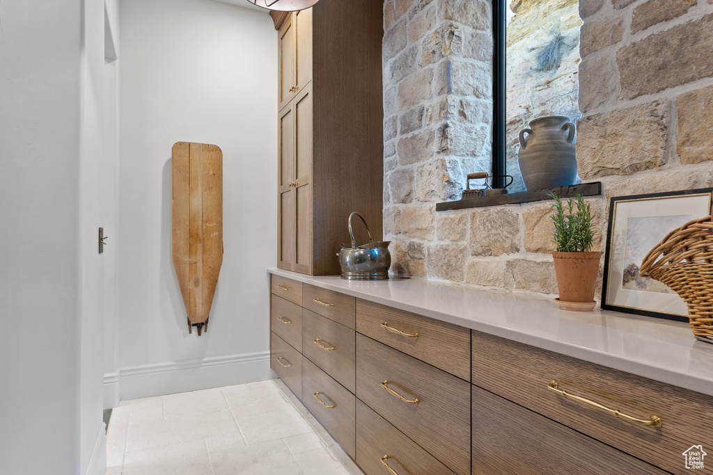 Bathroom with tile patterned floors and baseboards