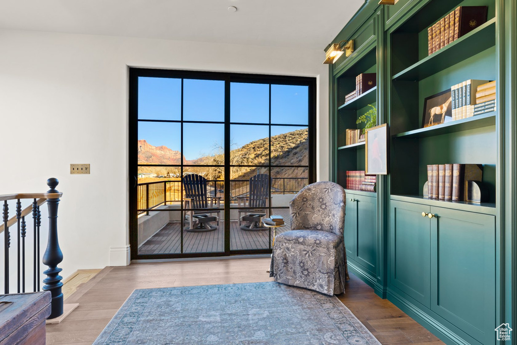 Sitting room featuring a mountain view, wood finished floors, and built in features