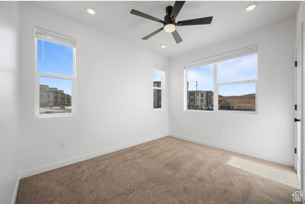 Spare room with carpet floors, recessed lighting, ceiling fan, and baseboards