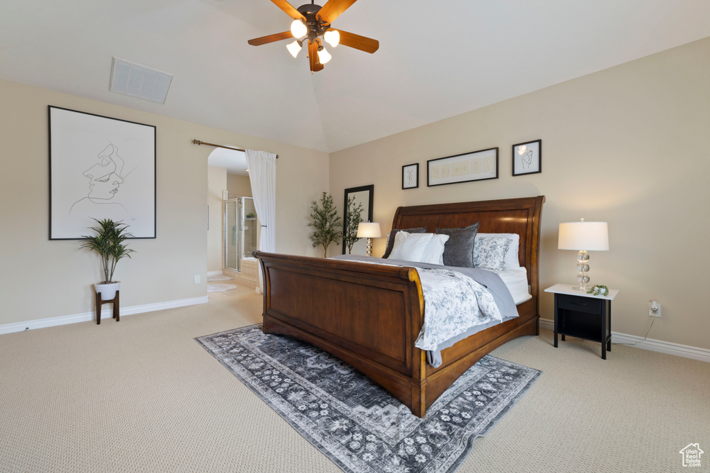 Bedroom with visible vents, baseboards, arched walkways, light colored carpet, and lofted ceiling