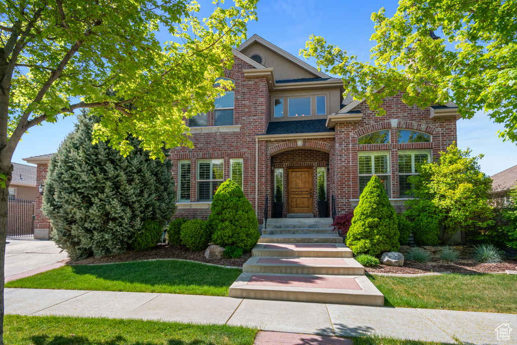 Traditional-style home featuring brick siding