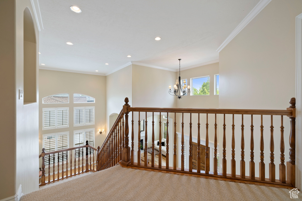 Hall with an inviting chandelier, carpet floors, an upstairs landing, and recessed lighting