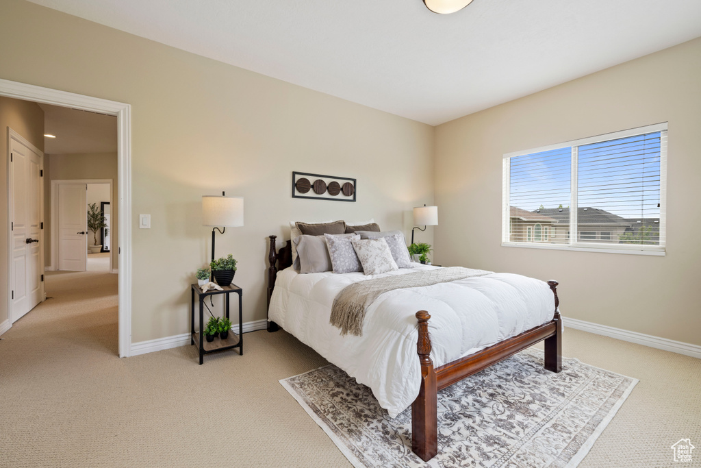 Bedroom with light carpet and baseboards