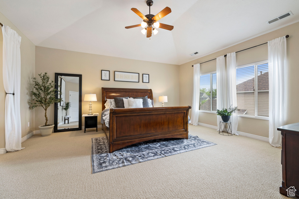Bedroom featuring lofted ceiling, carpet floors, baseboards, and visible vents