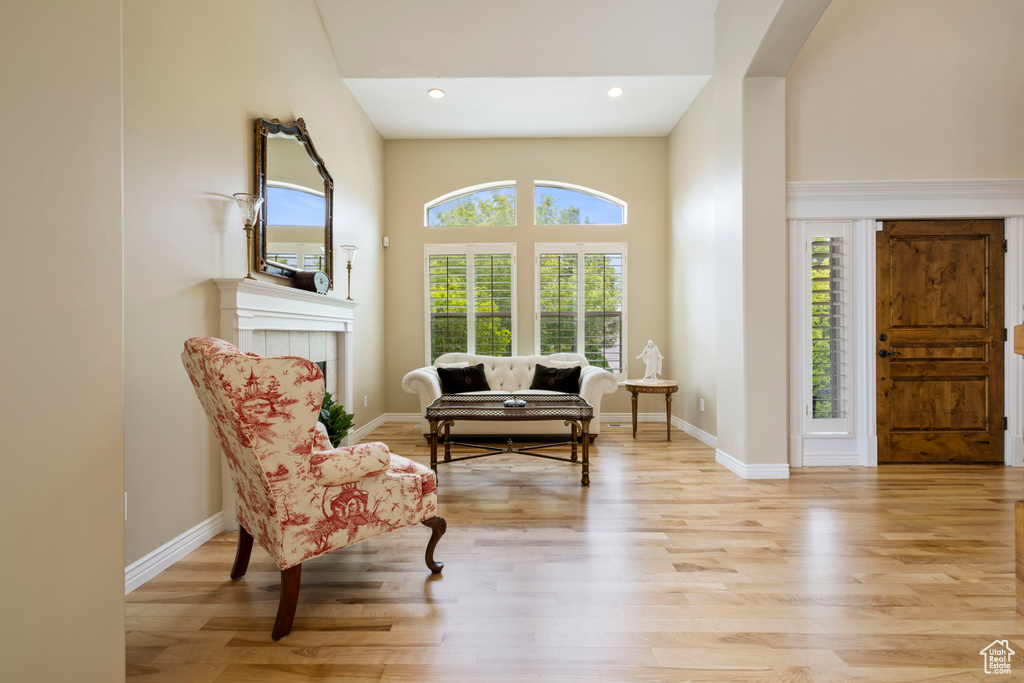 Sitting room with baseboards, light wood-type flooring, and recessed lighting