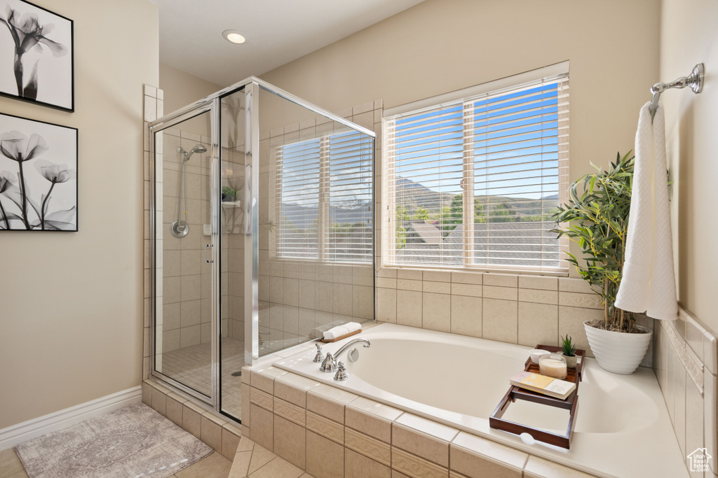 Full bathroom featuring a garden tub, baseboards, recessed lighting, tile patterned floors, and a shower stall