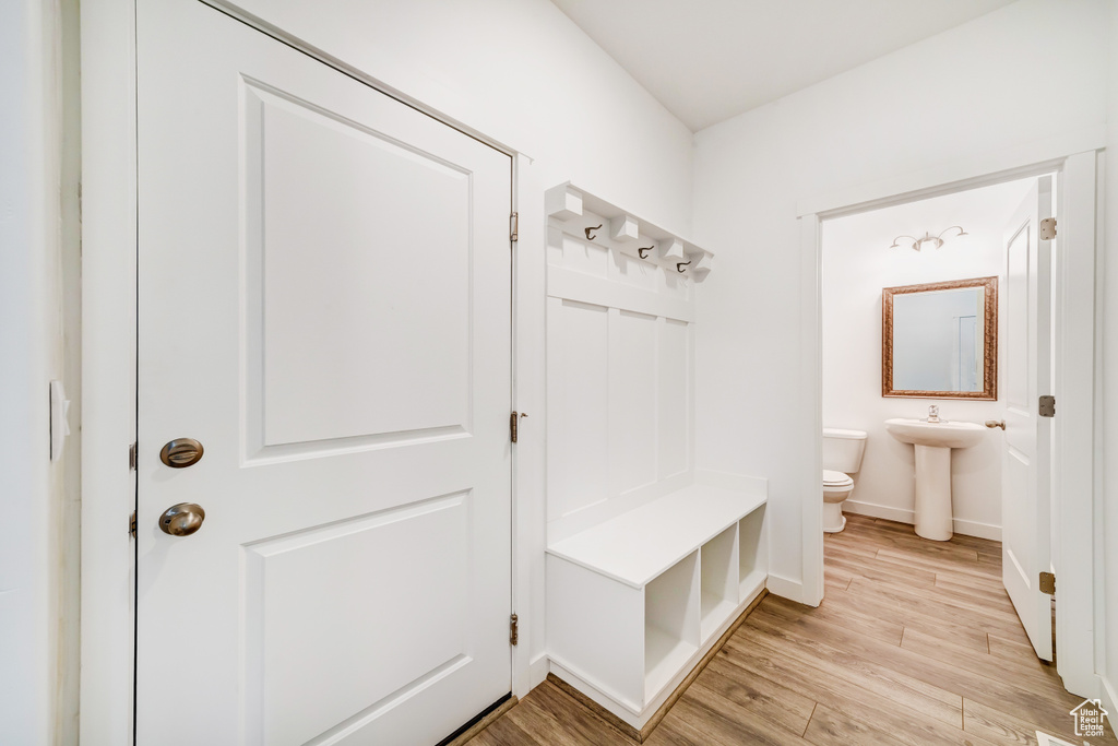Mudroom with baseboards and light wood finished floors