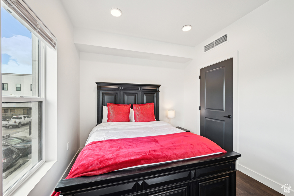 Bedroom featuring baseboards, dark wood-type flooring, recessed lighting, and visible vents