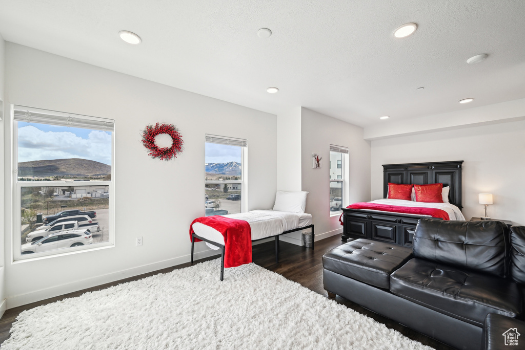 Bedroom with recessed lighting, baseboards, a mountain view, and dark wood-style floors