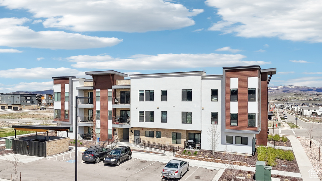 View of property with uncovered parking