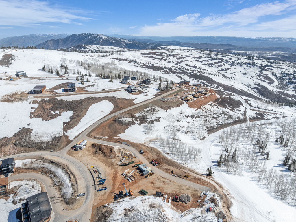 Snowy aerial view featuring a mountain view