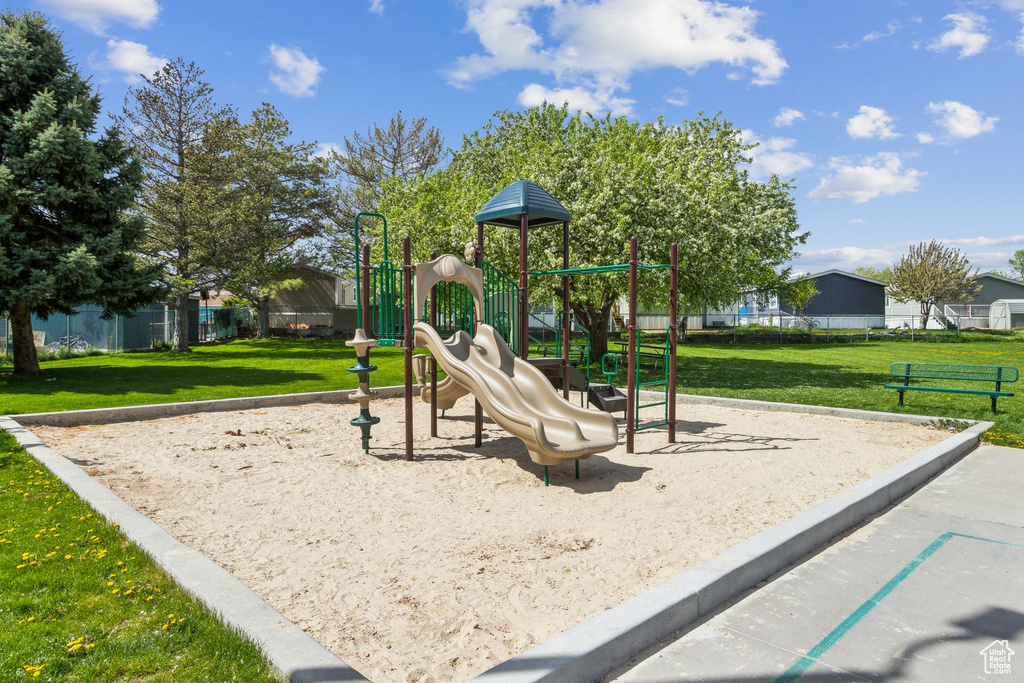 Community playground featuring a yard and fence
