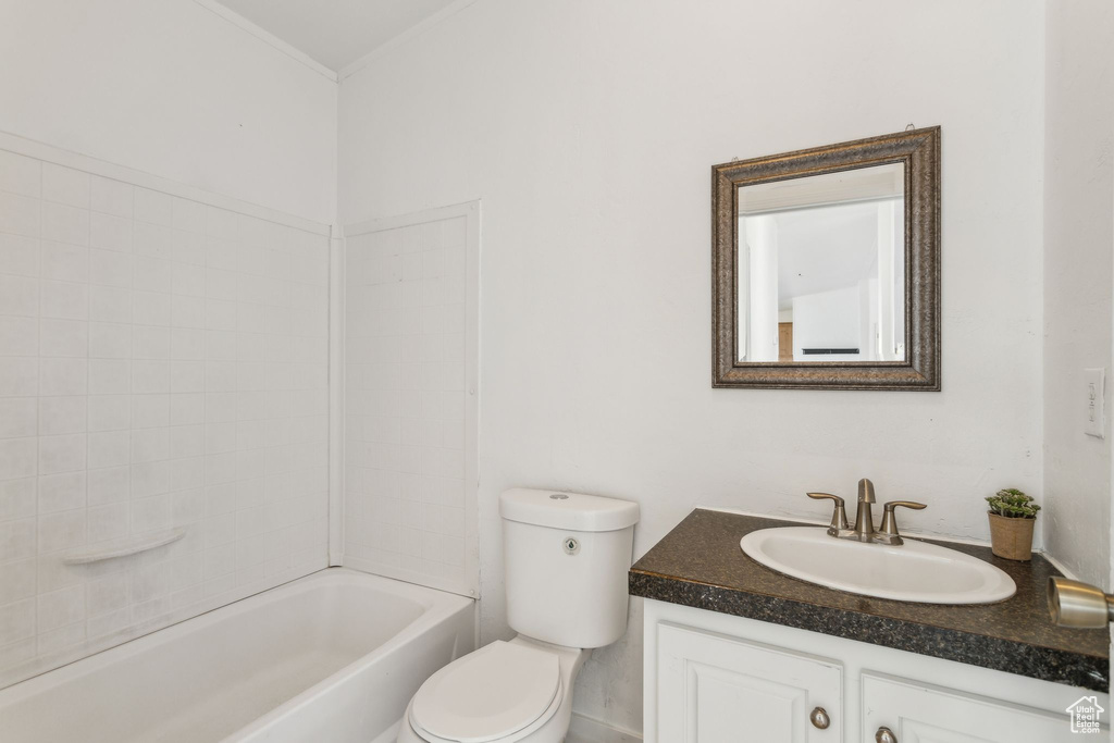 Bathroom featuring vanity, shower / bathing tub combination, and toilet