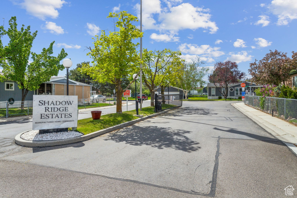 View of road featuring street lights, traffic signs, a residential view, and curbs