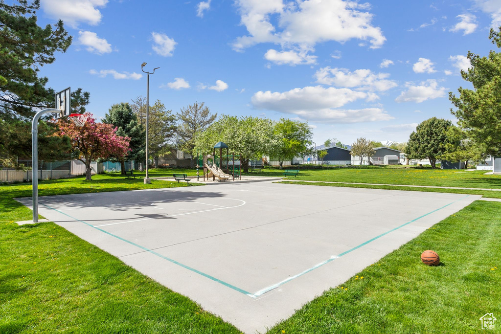 View of basketball court with a yard, community basketball court, and playground community