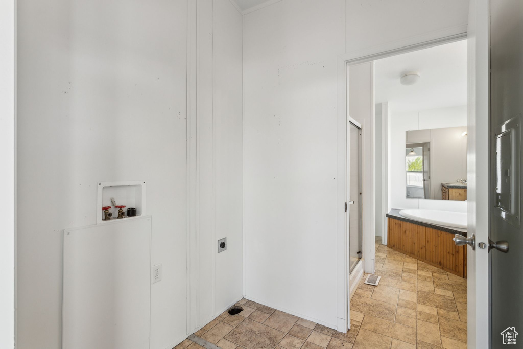 Laundry room featuring electric dryer hookup, stone finish flooring, laundry area, and hookup for a washing machine