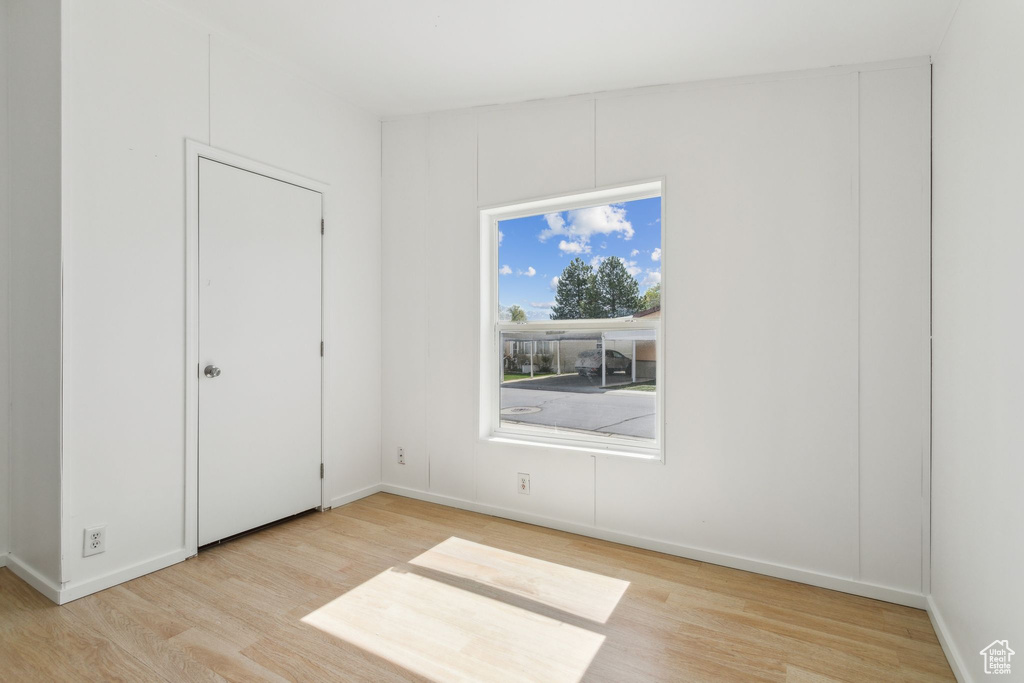 Unfurnished bedroom with baseboards and wood finished floors