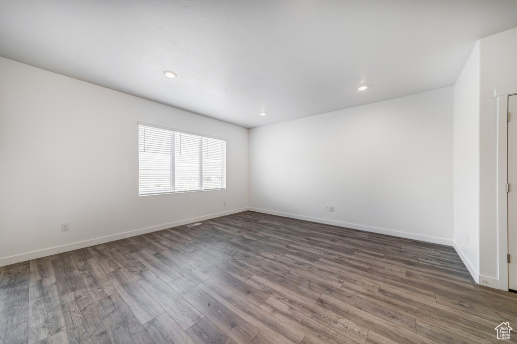 Unfurnished room with baseboards, recessed lighting, and wood finished floors