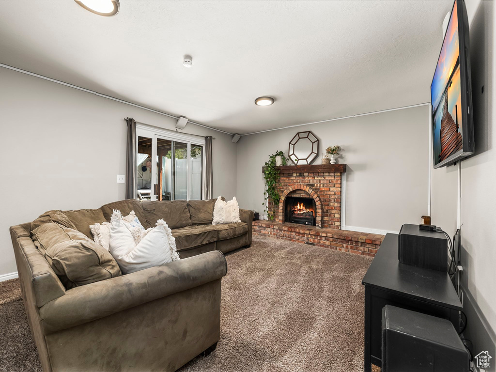 Living area with carpet flooring and a fireplace