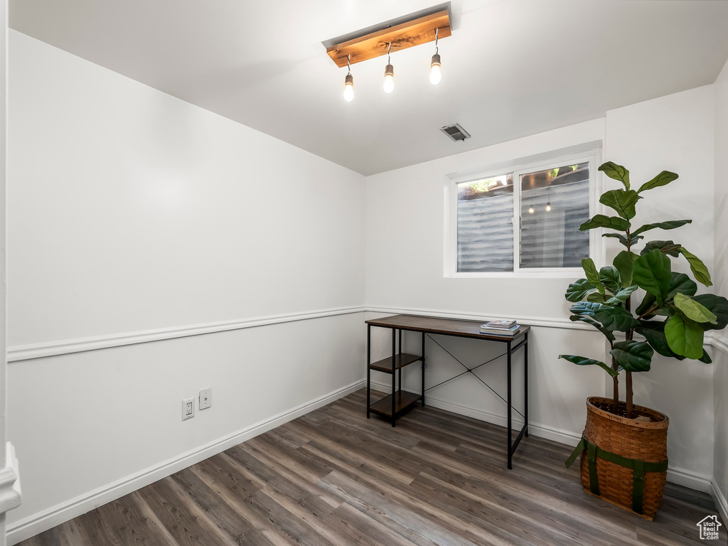 Interior space featuring visible vents, baseboards, and wood finished floors