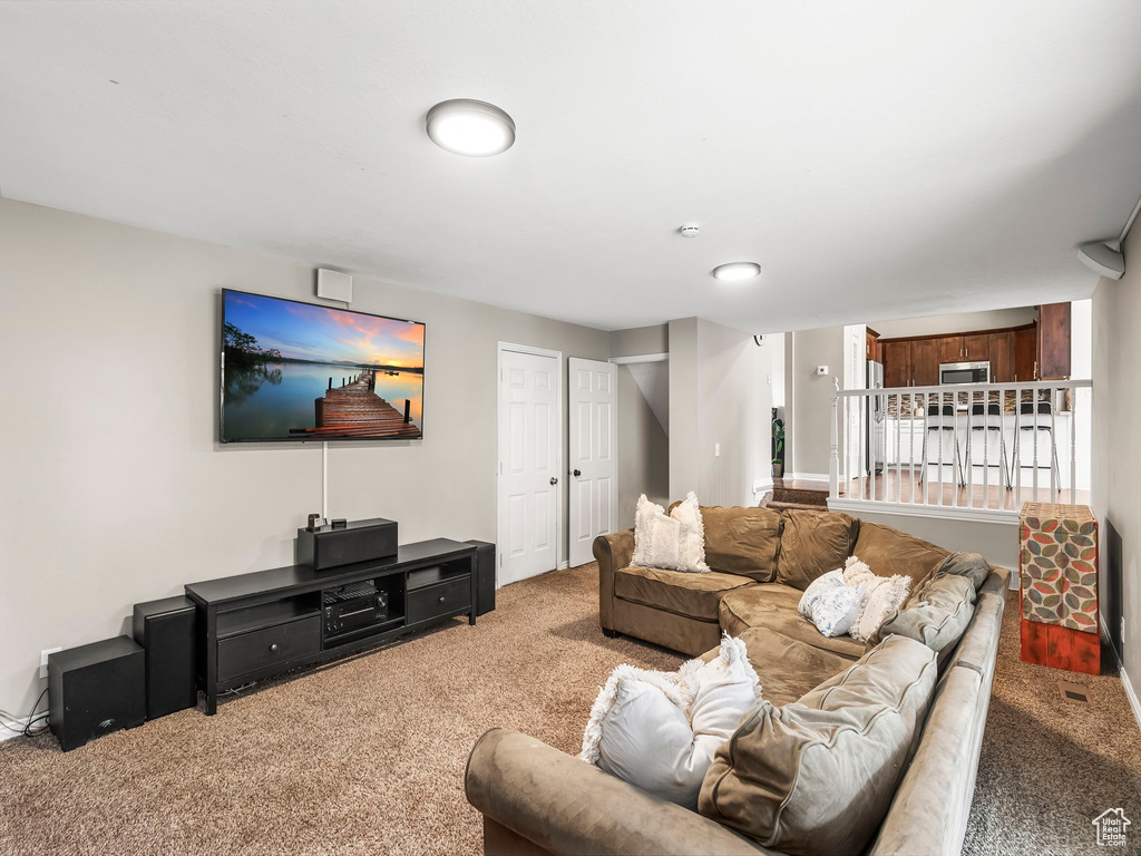 Living room with baseboards and carpet