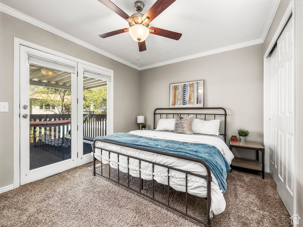 Bedroom featuring crown molding, carpet flooring, a closet, and access to exterior